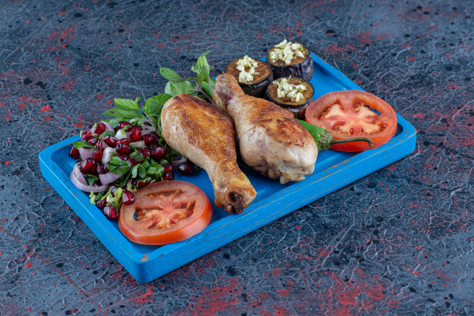 traditional Greek platter with grilled chicken and vegetables